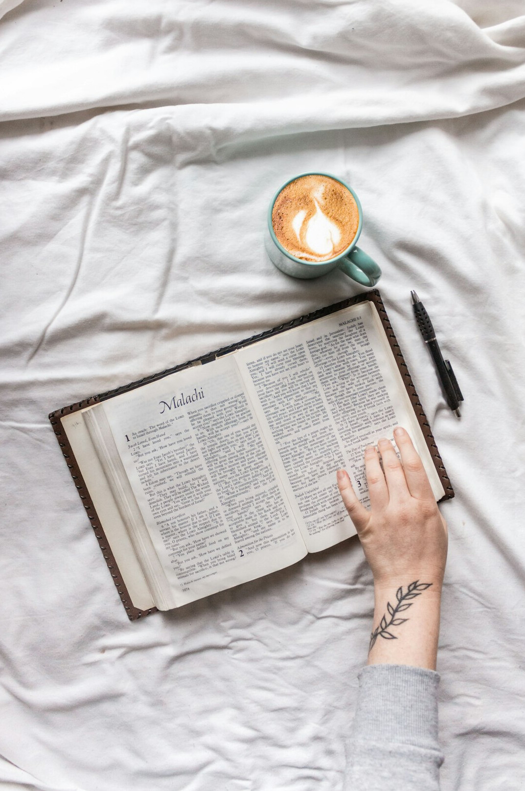 Hand writing in a notebook with a pen